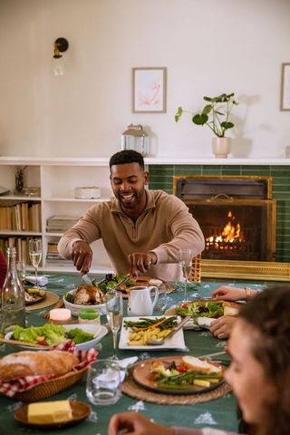 Friends celebrating feast with rustic roast poultry
