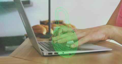 Digital security animations overlaying hands typing on laptop