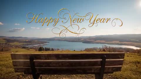 Happy New Year Golden Script Over Hilltop Bench Lake View - Relaxing New Year Greeting Video