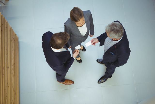 Top view of business executives giving business cards to each other