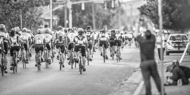 Cyclists Competing in Road Race with Onlookers Cheering - Download Free Stock Images Pikwizard.com