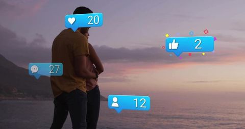 Couple embracing and gazing at coastal sunset with social media reaction overlays