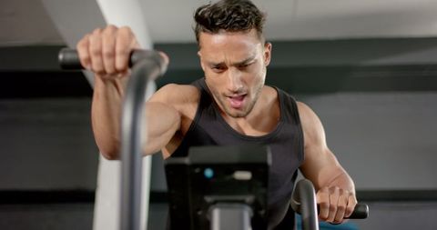 Intense Cardio Workout Man Exercising on Stationary Bike