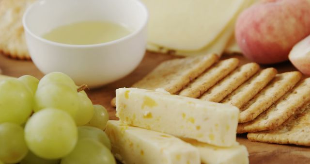 Close-Up of Cheese, Crackers, and Fruit on Wooden Board - Download Free Stock Images Pikwizard.com
