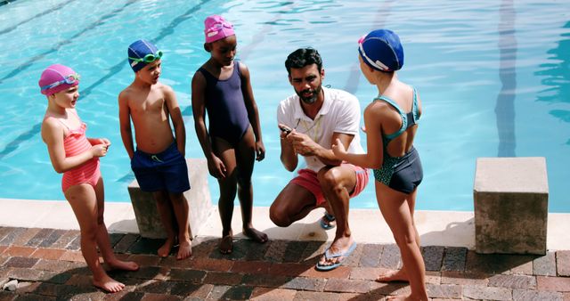 Swimming Coach Instructing Group of Children by Poolside - Download Free Stock Images Pikwizard.com