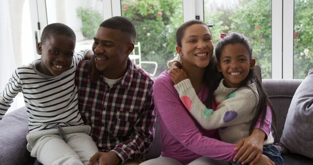 Happy Family of Four Laughing on Cozy Couch at Home - Download Free Stock Images Pikwizard.com