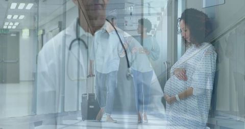 Pregnant Woman Sitting in Hospital Ward with Doctor in Corridor