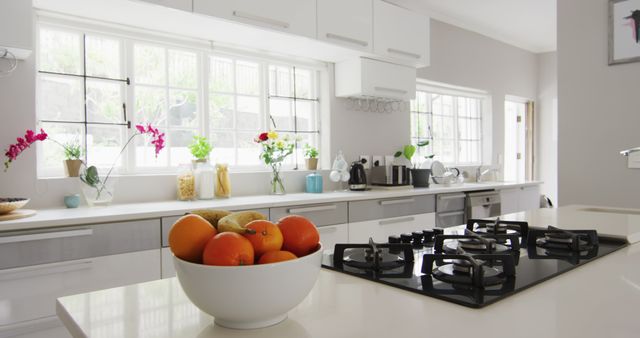 Image of bowl of oranges in modern and bright kitchen. Interior design, modern interiors, domestic life and lifestyle concept.