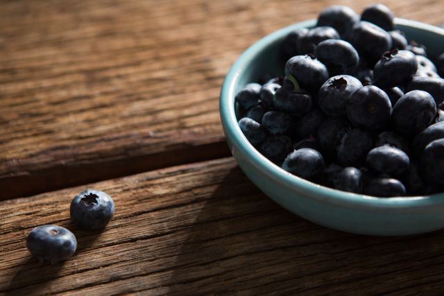 Bowl of blueberries on wooden table