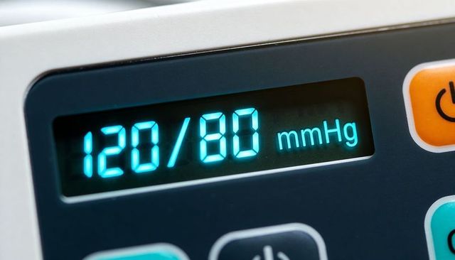 Digital blood pressure monitor showing 120/80 mmhg closeup led display medical device