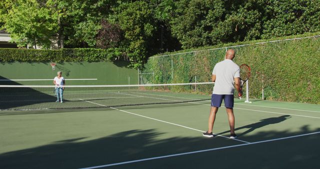 Two Friends Playing Tennis on Outdoor Court on Sunny Day - Download Free Stock Images Pikwizard.com