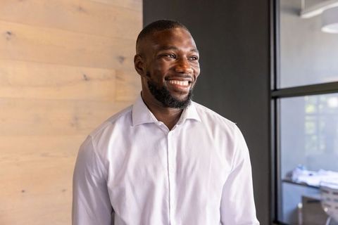 Confident Professional Standing in Modern Office Setting