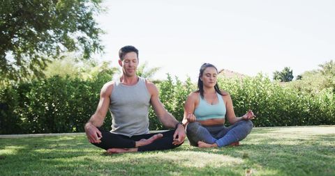 Caucasian Couple Practicing Yoga in Sunny Garden for Inner Peace