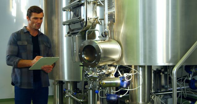 Industrial Worker Inspecting Modern Brewery Equipment - Download Free Stock Images Pikwizard.com