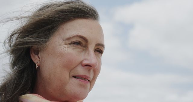 Elderly Woman Looking into Distance on a Breezy Day - Download Free Stock Images Pikwizard.com