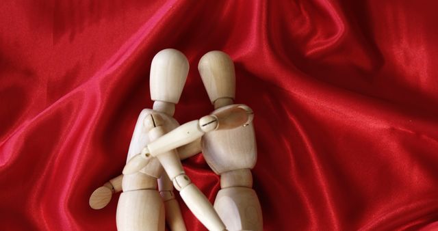 Wooden Mannequins Embracing on Red Satin Fabric Background - Download Free Stock Images Pikwizard.com