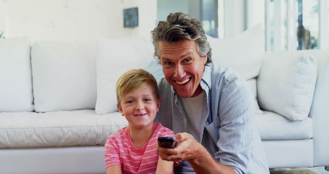 Happy Father and Son Watching TV Together at Home - Download Free Stock Images Pikwizard.com