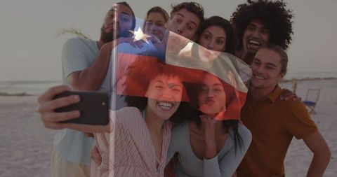 Friends enjoy sunset beach selfie with chilean flag overlay