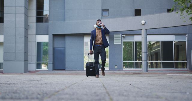 Business Traveler with Luggage Talking on Smartphone Outside Office Building - Download Free Stock Images Pikwizard.com