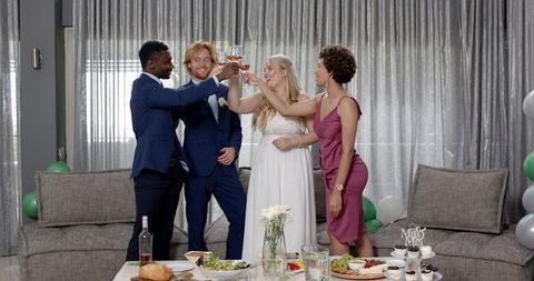 Diverse Group Toasting Joyful Wedding Celebration Home