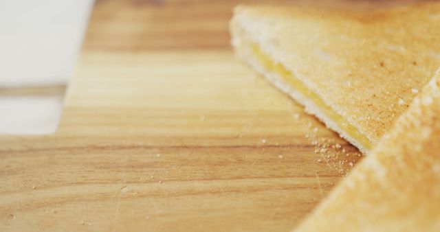 Image of slices of toasted cheese white bread sandwiches on wooden chopping board background. fusion food and fresh homemade snack concept.