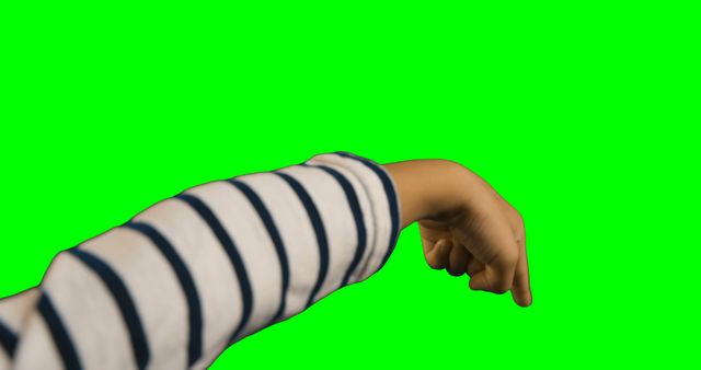 Child's Arm in Striped Sleeve Pointing Down on Green Background - Download Free Stock Images Pikwizard.com