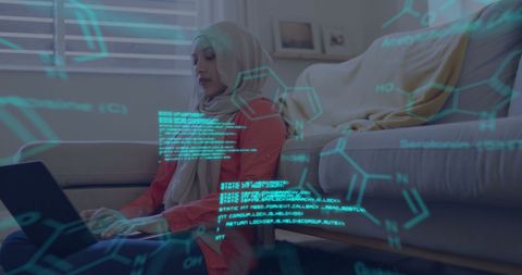 Hijabi Woman Engages in Scientific Data Processing with Laptop at Home