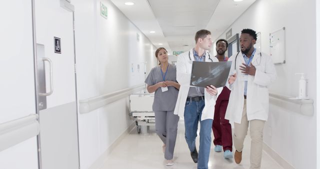 Medical Team Discussing Patient X-ray in Hospital Corridor - Download Free Stock Images Pikwizard.com