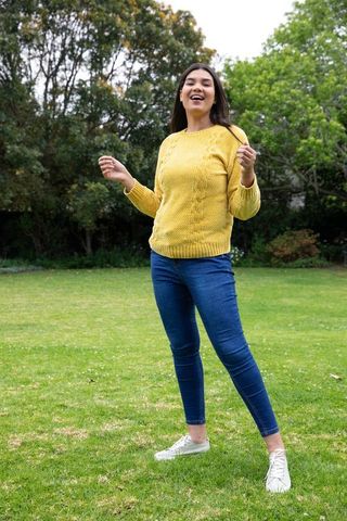 Young woman enjoying outdoor leisure in green field