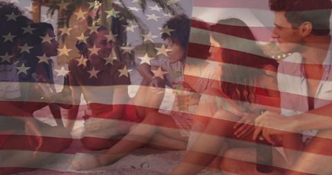 Friends enjoying beach party at sunset with american flag overlay and drinks