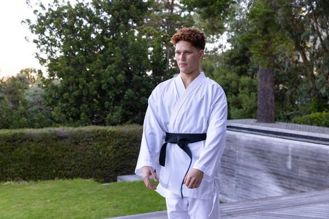 Karate Student Practicing Outdoors in Harmonious Natural Setting