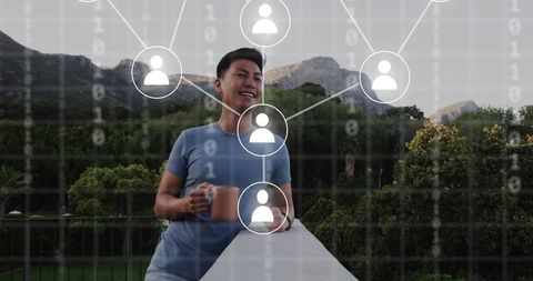 Standing Asian man holding mug on balcony with digital network overlay connecting people