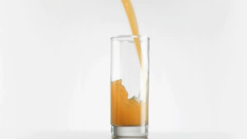 Refreshing Mango Juice Pour in Glass in Slow Motion