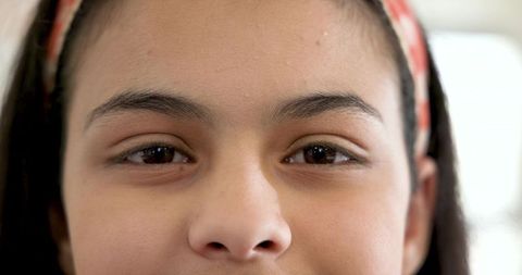 Portrait of young girl with patterned headband in bright light