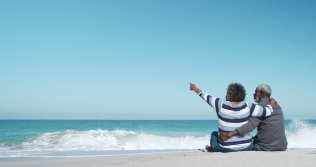 Senior Couple Sitting on Beach Admiring Ocean Waves - Download Free Stock Images Pikwizard.com