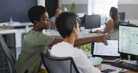 Creative Professionals Collaborating on Designs in Modern Office