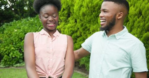 Joyful Couple Celebrating Engagement in Vibrant Park