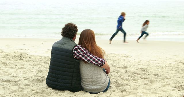 Family Enjoying Day at Beach with Parents Relaxing on Sand - Download Free Stock Images Pikwizard.com