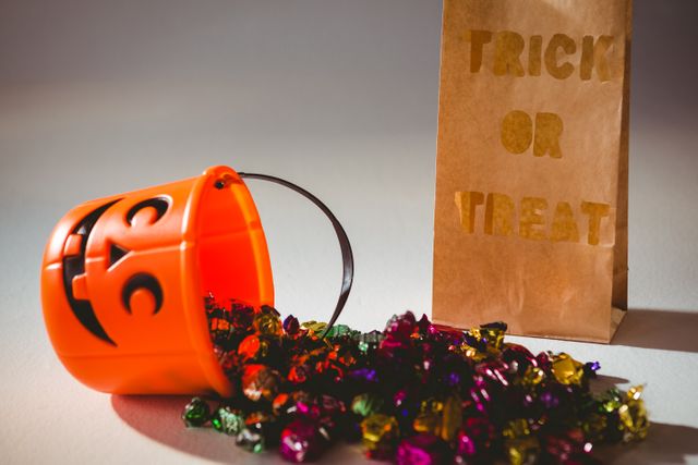 Trick or Treat Bag and Candy Bucket with Colorful Chocolates - Download Free Stock Photos Pikwizard.com