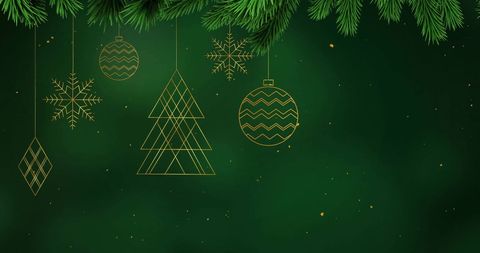 Holiday ornaments and pine branches on green background