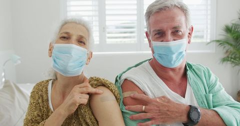 Senior couple vaccinated with bandages visible, promoting health care