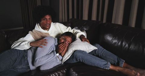 Cozy African American Couple Relaxing on Leather Sofa at Home