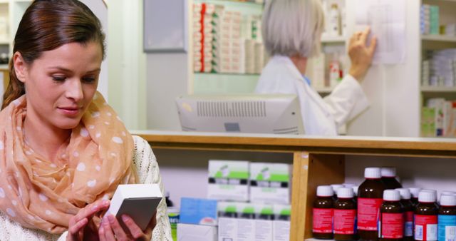 Portrait of customer holding a medicine box in pharmacy