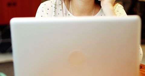 Businesswoman working on laptop at cafe