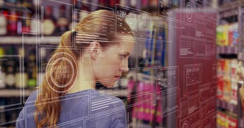 Mid-Adult Woman Scanning Product Labels with Augmented Reality HUD in Retail Aisle