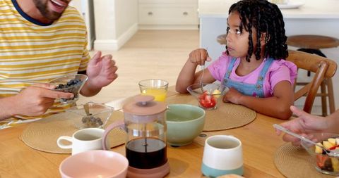 Diverse Family Sharing Breakfast Together in Home Kitchen