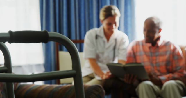 Nurse consulting with elderly patient at home - Download Free Stock Images Pikwizard.com