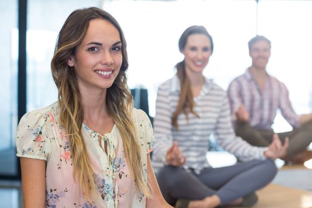 Portrait of business people performing yoga in office