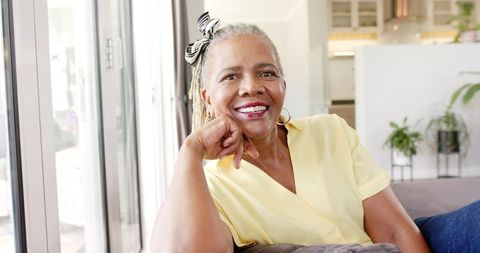 Joyful Senior African American Woman Seated Indoors