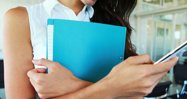 Businesswoman Holding Documents Looking at Smartphone - Download Free Stock Images Pikwizard.com